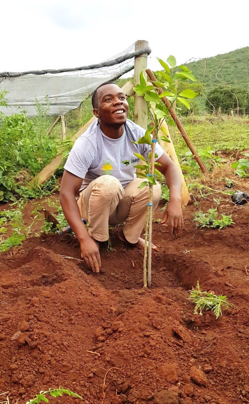 Zimisele Luthuli beside a newly planted lemon tree at Ubhejane Crèche